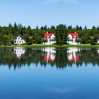 Typical summer view - cityscape of Reykjavik, capital of Iceland - lake shore with reflections in water. Von Studio Dagdagaz